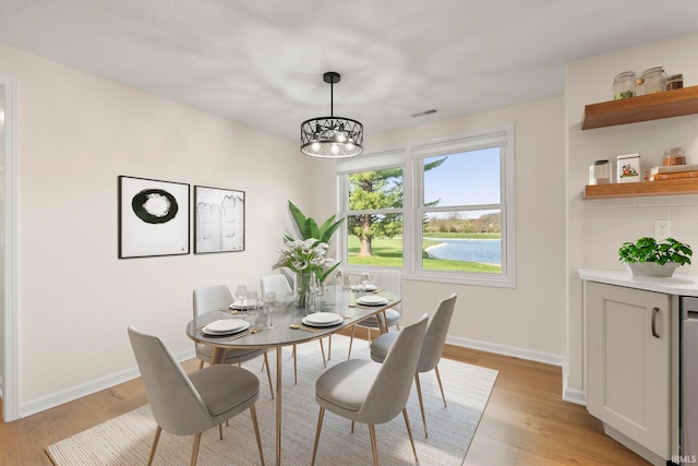 11136 N 200 W, Ossian, IN 46777 - dining room with baseboards, a chandelier, and light wood-style floors