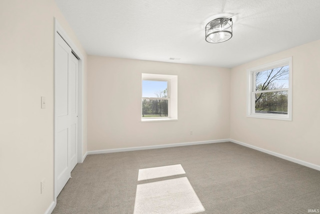 11136 N 200 W, Ossian, IN 46777 - unfurnished bedroom featuring light carpet, baseboards, and a closet