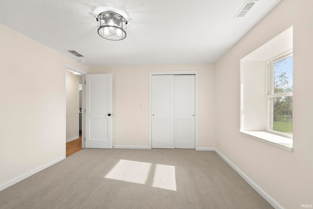 11136 N 200 W, Ossian, IN 46777 - unfurnished bedroom featuring light colored carpet, baseboards, and a closet
