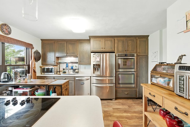 2090 S Warren Rd, Huntington, IN 46750 - kitchen with appliances with stainless steel finishes, light wood-style flooring, and light countertops
