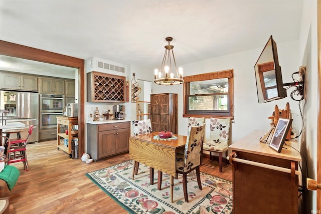 2090 S Warren Rd, Huntington, IN 46750 - dining room featuring a chandelier and light wood-style floors