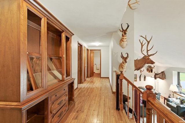 2090 S Warren Rd, Huntington, IN 46750 - hallway featuring light wood-type flooring and an upstairs landing