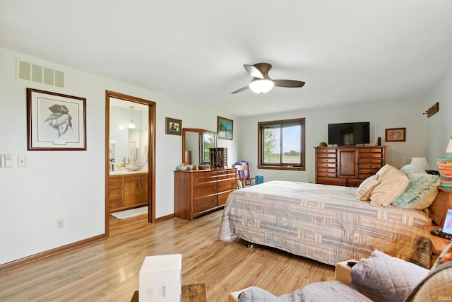 2090 S Warren Rd, Huntington, IN 46750 - bedroom featuring light wood-style flooring, ceiling fan, and ensuite bath