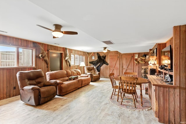 2090 S Warren Rd, Huntington, IN 46750 - living area with wooden walls, a ceiling fan, and wood finished floors