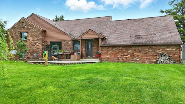 2090 S Warren Rd, Huntington, IN 46750 - back of house featuring brick siding, a lawn, and a deck