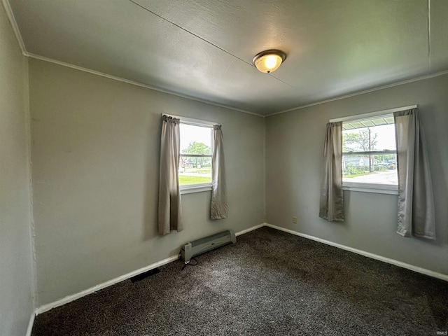 4314 Smith St, Fort Wayne, IN 46806 - empty room with a baseboard heating unit, plenty of natural light, ornamental molding, dark carpet, and baseboards