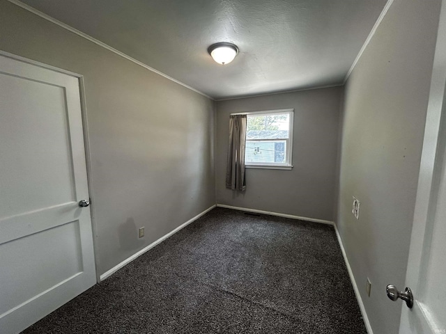 4314 Smith St, Fort Wayne, IN 46806 - spare room featuring dark colored carpet, baseboards, and crown molding