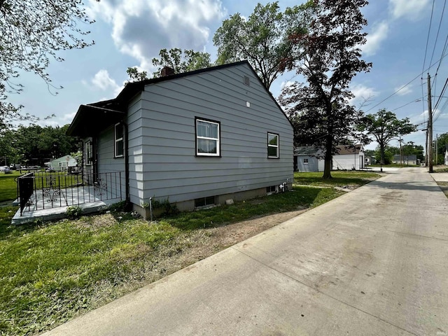 4314 Smith St, Fort Wayne, IN 46806 - view of home's exterior featuring a chimney and a yard