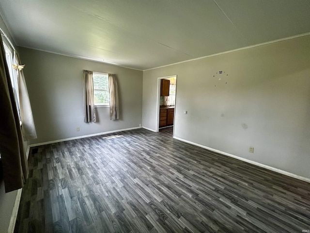 4314 Smith St, Fort Wayne, IN 46806 - spare room featuring dark wood-style flooring, baseboards, and ornamental molding