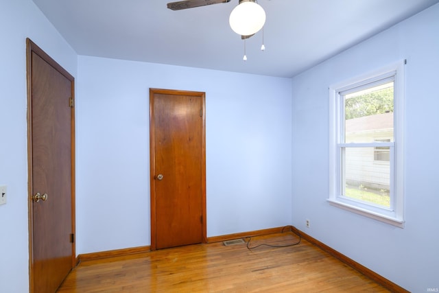 922 N Broadway St, Seymour, IN 47274 - unfurnished bedroom featuring baseboards, light wood finished floors, and a ceiling fan