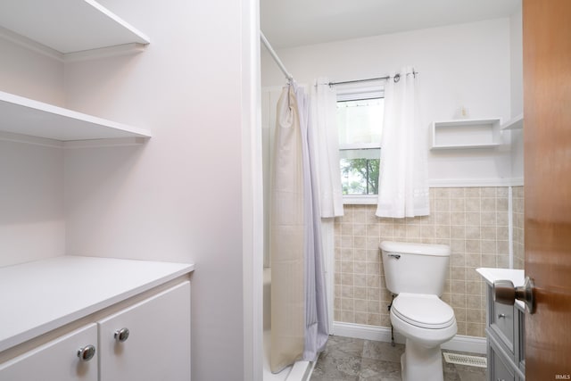 922 N Broadway St, Seymour, IN 47274 - bathroom with vanity, toilet, a shower with curtain, and tile walls