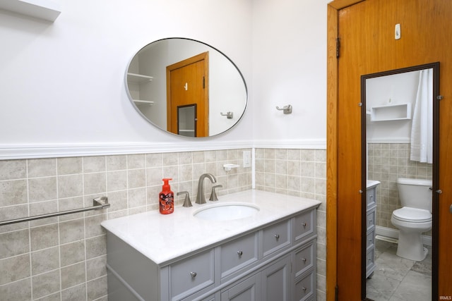 922 N Broadway St, Seymour, IN 47274 - bathroom featuring tile walls, vanity, toilet, and a wainscoted wall