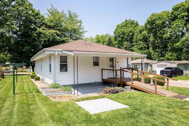 922 N Broadway St, Seymour, IN 47274 - view of front facade with a patio area, a front lawn, a wooden deck, and a shingled roof