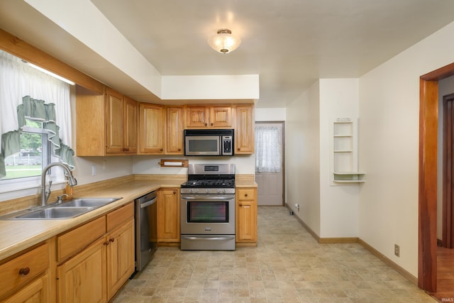922 N Broadway St, Seymour, IN 47274 - kitchen with appliances with stainless steel finishes, a sink, light countertops, and baseboards