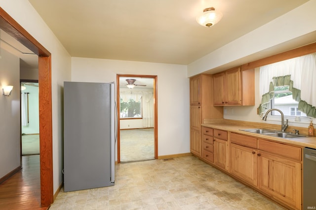 922 N Broadway St, Seymour, IN 47274 - kitchen with stainless steel appliances, a sink, light countertops, and baseboards