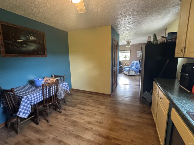 14512 Old State Road 37, Tell City, IN 47586 - dining space featuring light wood-type flooring, a textured ceiling, baseboards, and ceiling fan