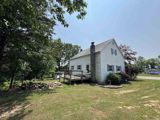 14512 Old State Road 37, Tell City, IN 47586 - view of property exterior with a chimney, a lawn, a wooden deck, and metal roof