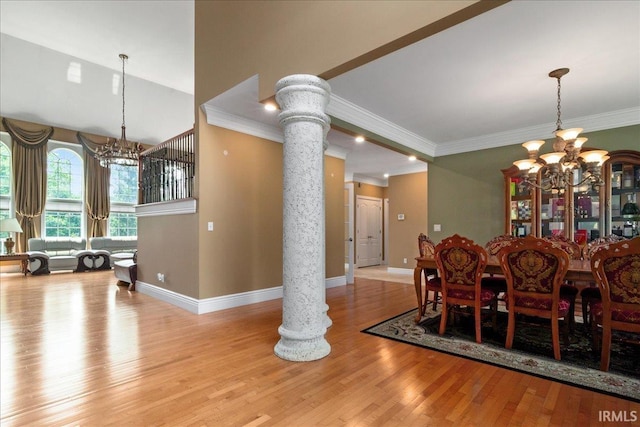 6444 Pebble Pointe Ct, Newburgh, IN 47630 - dining room featuring a chandelier, wood finished floors, decorative columns, baseboards, and crown molding