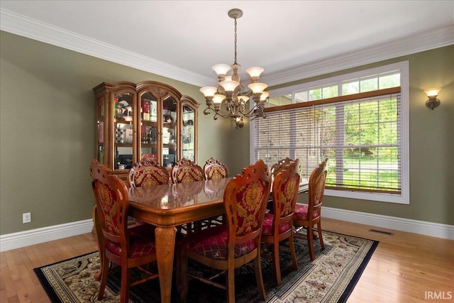 6444 Pebble Pointe Ct, Newburgh, IN 47630 - dining space featuring a chandelier, baseboards, plenty of natural light, ornamental molding, and wood finished floors