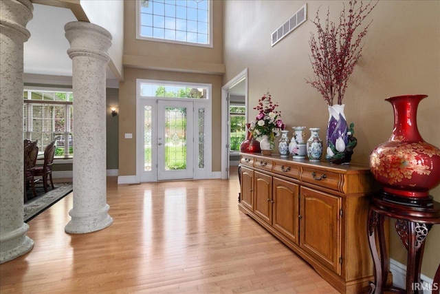 6444 Pebble Pointe Ct, Newburgh, IN 47630 - foyer entrance featuring ornate columns, light wood finished floors, baseboards, and a towering ceiling