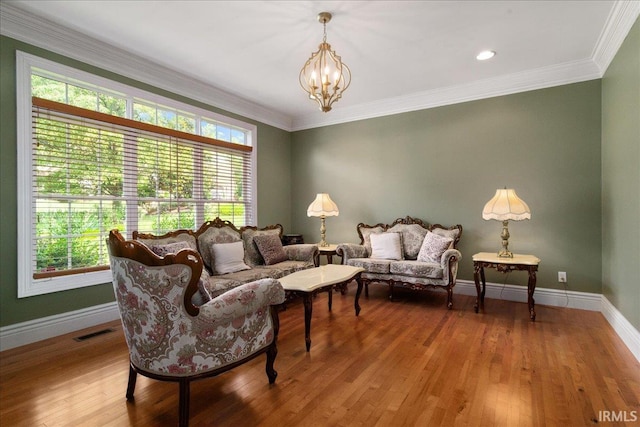 6444 Pebble Pointe Ct, Newburgh, IN 47630 - living area with a chandelier, wood finished floors, baseboards, and crown molding