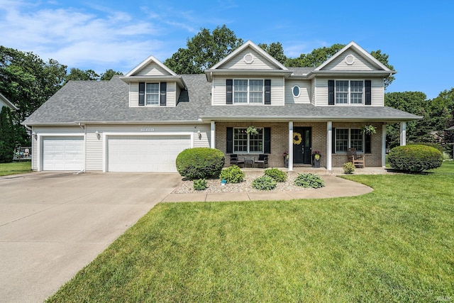 58201 Windsong Dr, Elkhart, IN 46517 - view of front of home with an attached garage, concrete driveway, covered porch, a shingled roof, and a front yard