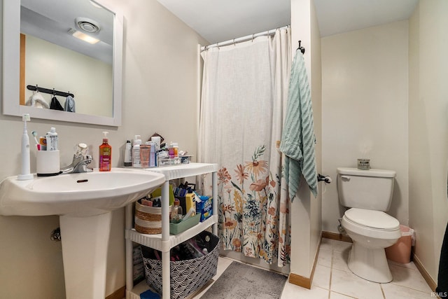 58201 Windsong Dr, Elkhart, IN 46517 - full bathroom featuring toilet, a shower with curtain, tile patterned floors, and baseboards