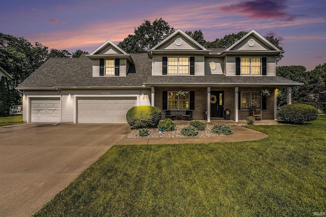58201 Windsong Dr, Elkhart, IN 46517 - traditional-style home with a porch, concrete driveway, an attached garage, a lawn, and roof with shingles