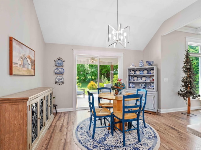 10805 Eagle River Run, Fort Wayne, IN 46845 - dining room with vaulted ceiling, light wood finished floors, a chandelier, and baseboards