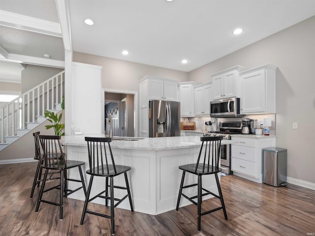 10805 Eagle River Run, Fort Wayne, IN 46845 - kitchen with appliances with stainless steel finishes, white cabinets, a peninsula, baseboards, and recessed lighting