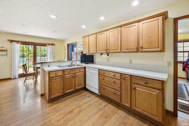 61587 Brompton Rd, South Bend, IN 46614 - kitchen with dishwasher, a peninsula, light wood finished floors, light countertops, and a sink