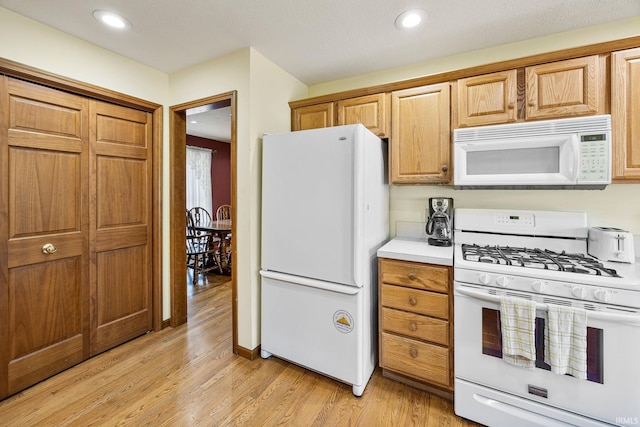61587 Brompton Rd, South Bend, IN 46614 - kitchen featuring white appliances, light wood-type flooring, light countertops, and recessed lighting