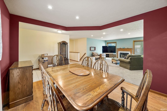61587 Brompton Rd, South Bend, IN 46614 - dining area featuring a fireplace, recessed lighting, light wood finished floors, and baseboards