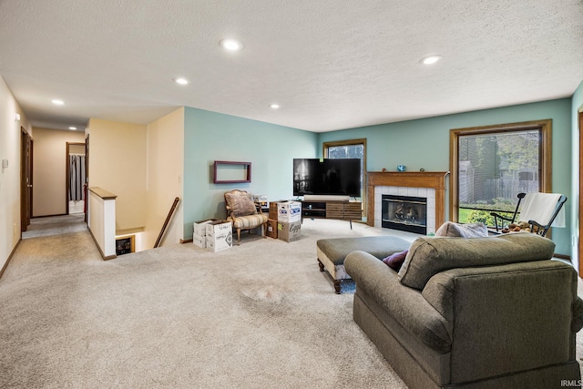 61587 Brompton Rd, South Bend, IN 46614 - carpeted living room featuring recessed lighting, a tiled fireplace, a textured ceiling, and baseboards