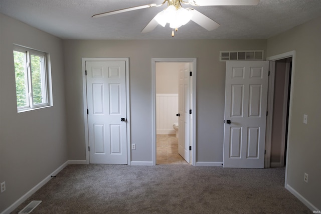 3289 S State Road 37th Rd, Paoli, IN 47454 - unfurnished bedroom featuring carpet floors, a textured ceiling, ensuite bath, baseboards, and ceiling fan