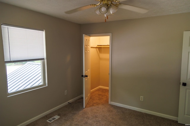 3289 S State Road 37th Rd, Paoli, IN 47454 - unfurnished bedroom with a spacious closet, carpet, a closet, baseboards, and ceiling fan