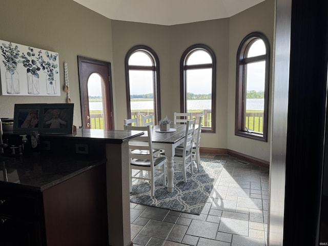 5533 N 150 Rd E, Urbana, IN 46990 - dining room with stone tile floors, plenty of natural light, a water view, and baseboards