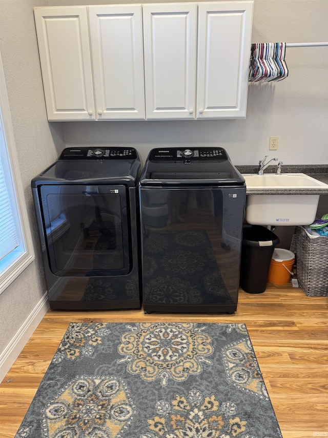 5533 N 150 Rd E, Urbana, IN 46990 - laundry area with wood finished floors, washer and dryer, baseboards, and cabinet space