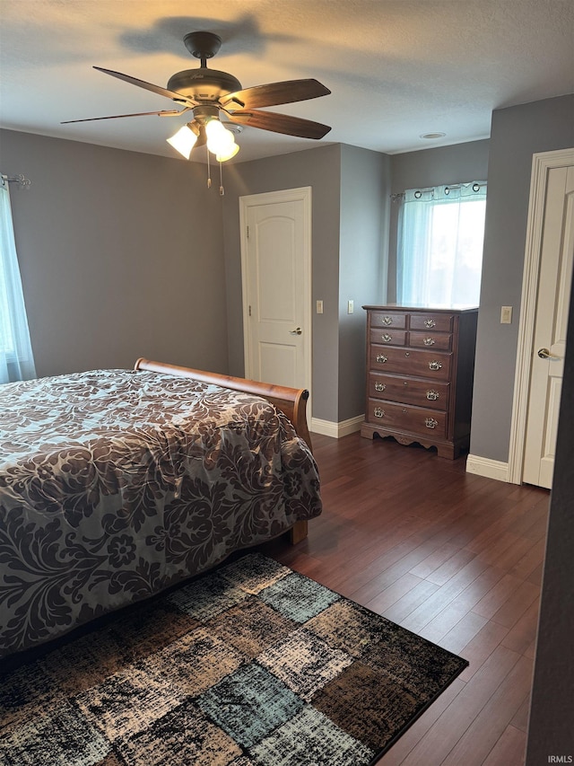 5533 N 150 Rd E, Urbana, IN 46990 - bedroom with baseboards, dark wood-type flooring, and ceiling fan