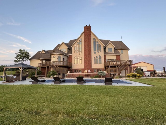 5533 N 150 Rd E, Urbana, IN 46990 - rear view of property featuring stairway, a gazebo, a chimney, brick siding, and a patio area