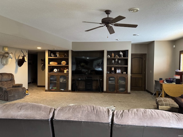 5533 N 150 Rd E, Urbana, IN 46990 - living area featuring carpet, ceiling fan, a textured ceiling, baseboards, and built in features