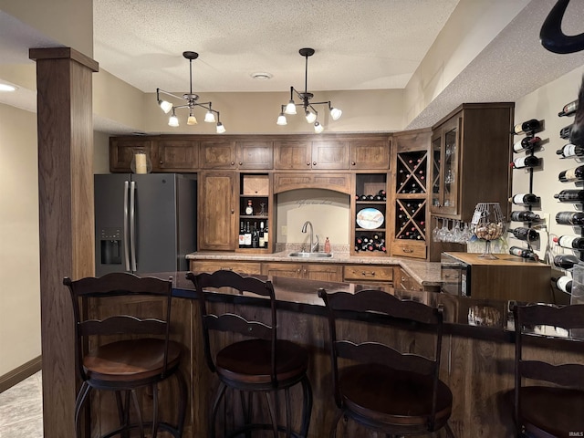 5533 N 150 Rd E, Urbana, IN 46990 - indoor wet bar featuring stainless steel fridge, a textured ceiling, and hanging light fixtures