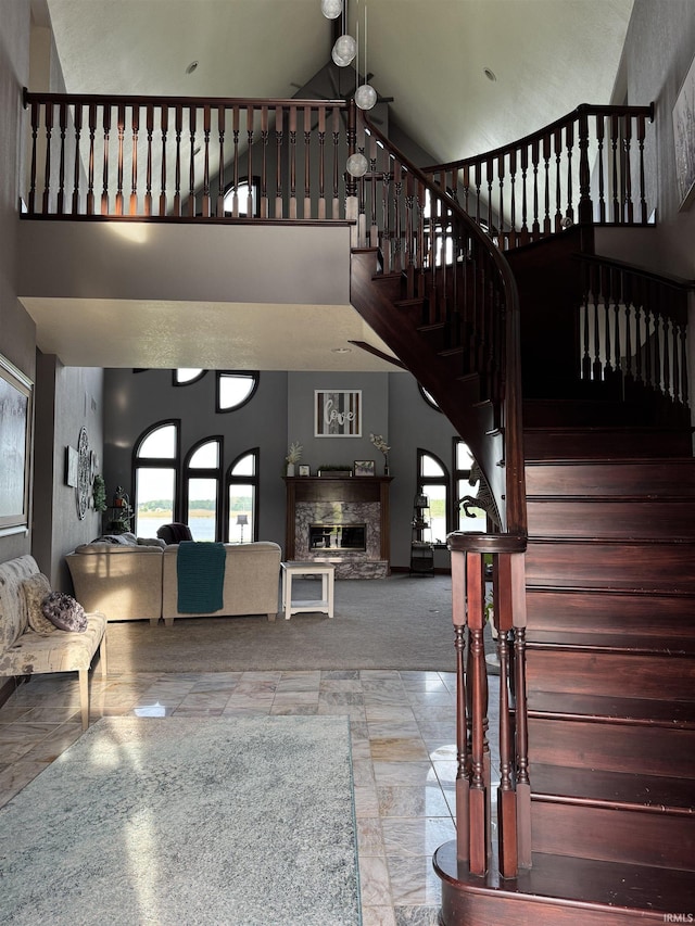 5533 N 150 Rd E, Urbana, IN 46990 - stairway with high vaulted ceiling and a glass covered fireplace