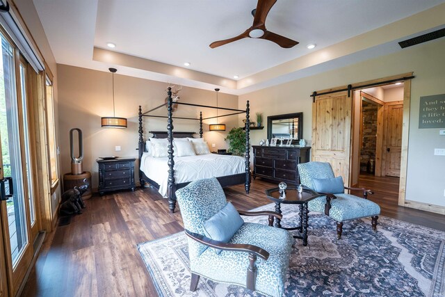 8615 W 450 S, Hudson, IN 46747 - bedroom with a barn door, a raised ceiling, wood finished floors, recessed lighting, and baseboards