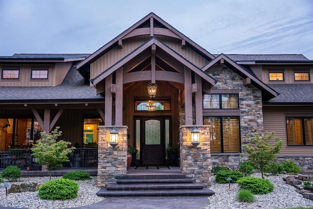 8615 W 450 S, Hudson, IN 46747 - view of exterior entry with board and batten siding, stone siding, and a shingled roof