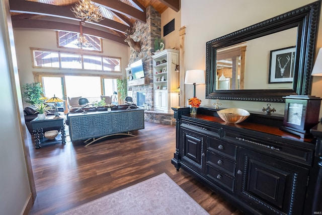 8615 W 450 S, Hudson, IN 46747 - living room featuring a chandelier, high vaulted ceiling, dark wood finished floors, beam ceiling, and a stone fireplace