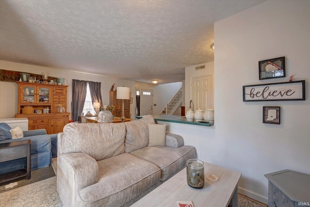 2881 S Walnut St Pike, Bloomington, IN 47401 - living room with stairway, a textured ceiling, and baseboards
