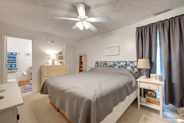 2881 S Walnut St Pike, Bloomington, IN 47401 - carpeted bedroom with a textured ceiling, a ceiling fan, and connected bathroom