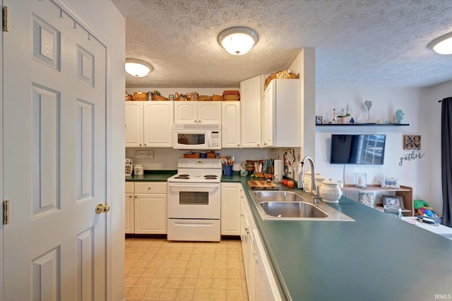 2881 S Walnut St Pike, Bloomington, IN 47401 - kitchen featuring white appliances, a sink, a textured ceiling, dark countertops, and white cabinets