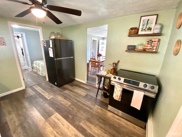 138 N Harrison St, Bloomfield, IN 47424 - kitchen with freestanding refrigerator, stainless steel electric range oven, a ceiling fan, wood finished floors, and a textured ceiling